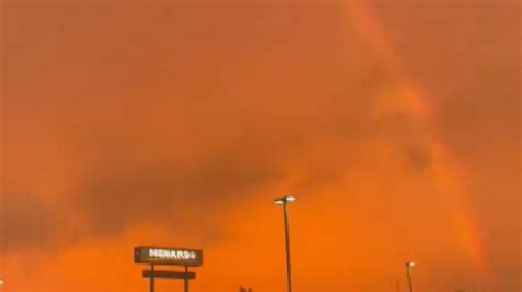 Minnesota: Lightning strikes and a rainbow forms during storm.